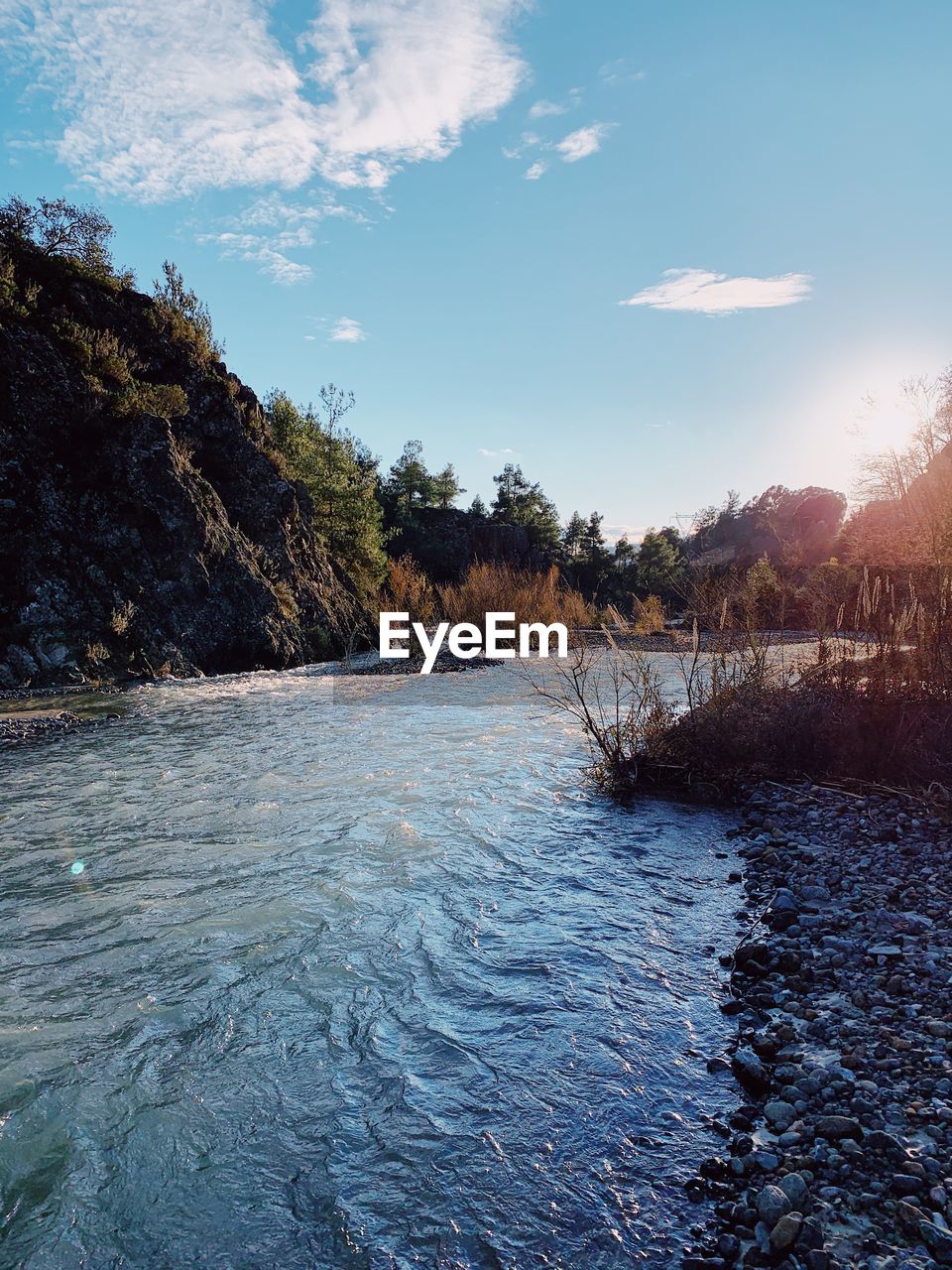 SCENIC VIEW OF RIVER FLOWING AGAINST SKY