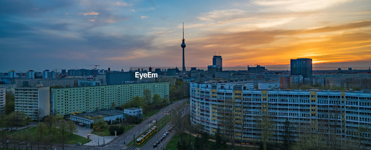 Buildings and television tower - berlin against sky during sunset