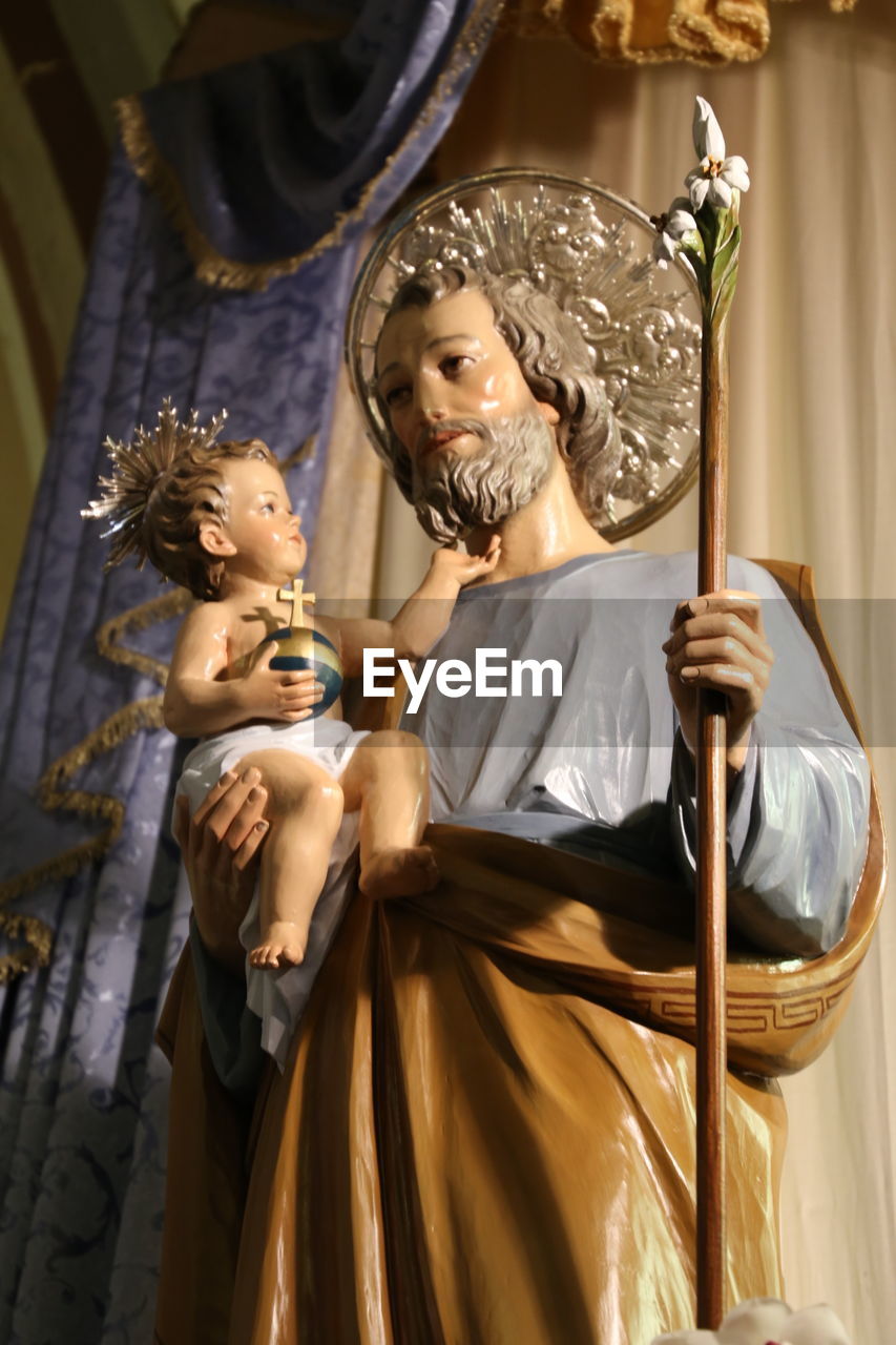 Low angle view of saint joseph with infant jesus statue in church