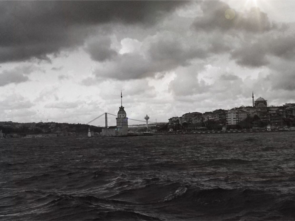 LIGHTHOUSE IN SEA AGAINST CLOUDY SKY