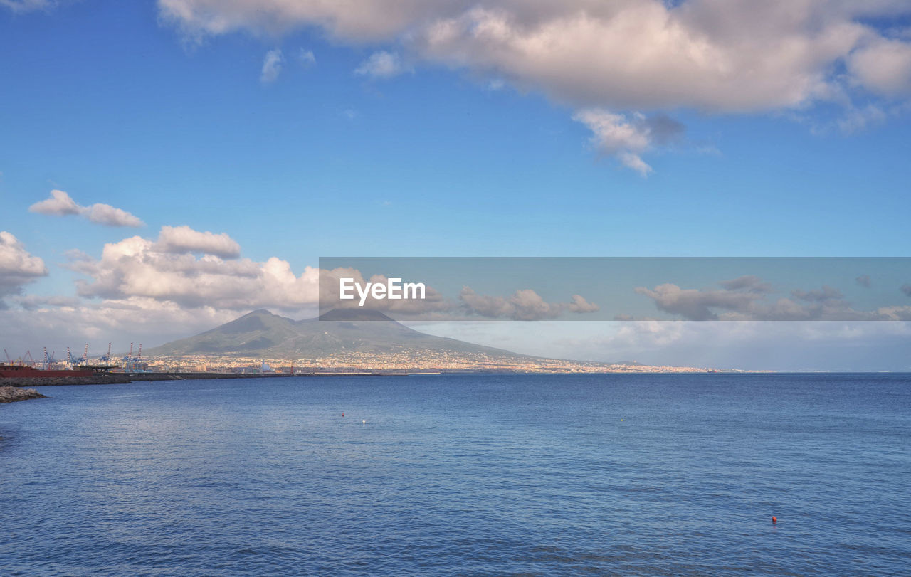 SCENIC VIEW OF SEA WITH MOUNTAIN IN BACKGROUND