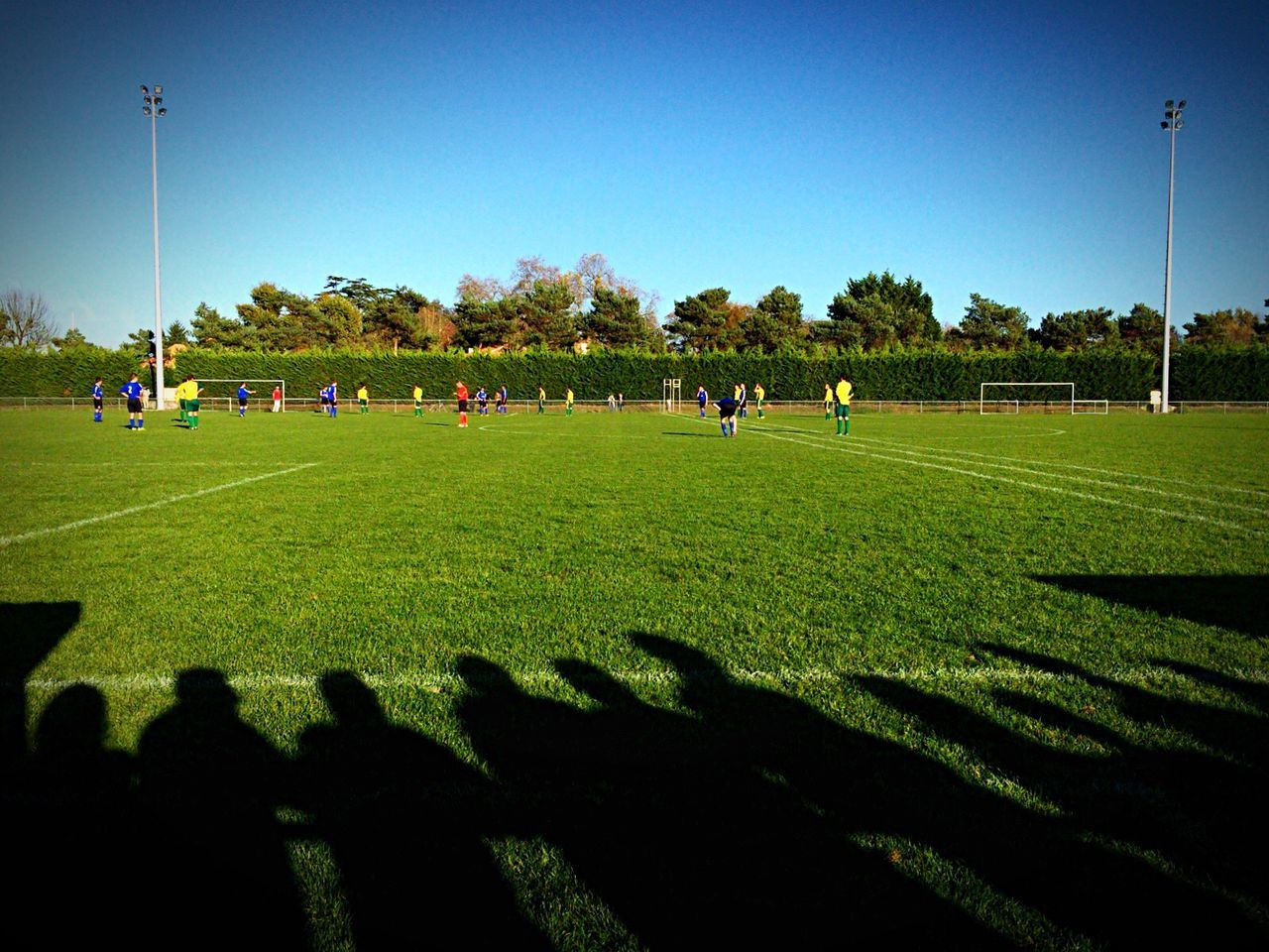 Shadow of spectators at soccer field