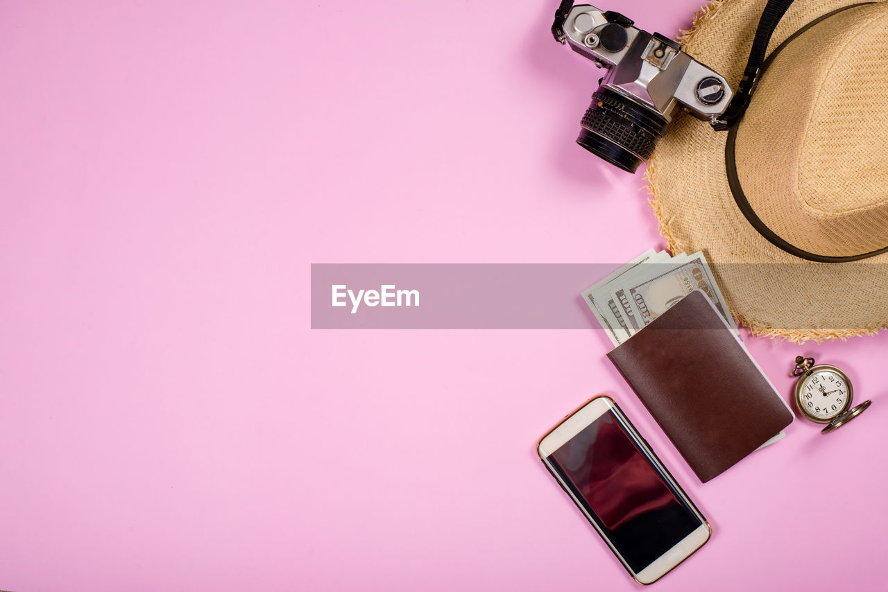 CLOSE-UP OF DIGITAL CAMERA ON TABLE AGAINST GRAY BACKGROUND