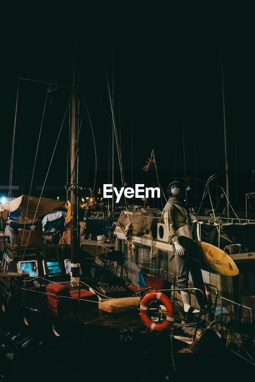 SAILBOATS MOORED AT HARBOR