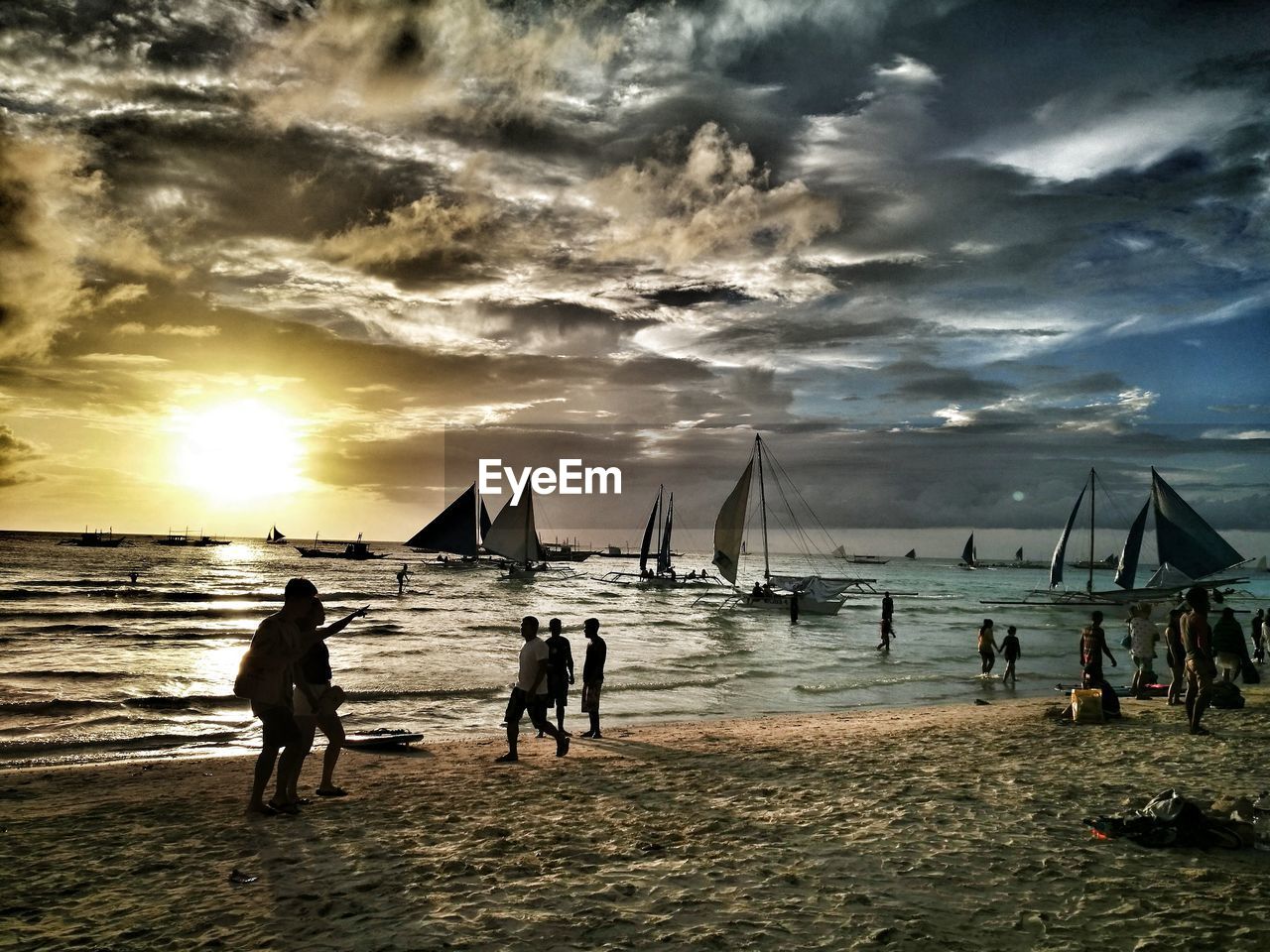 VIEW OF PEOPLE ON BEACH AGAINST SKY