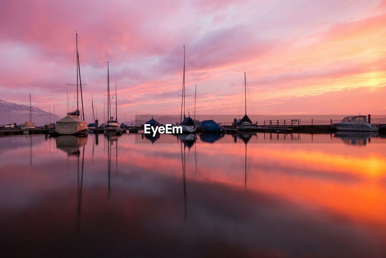 View of boats at harbor during sunset