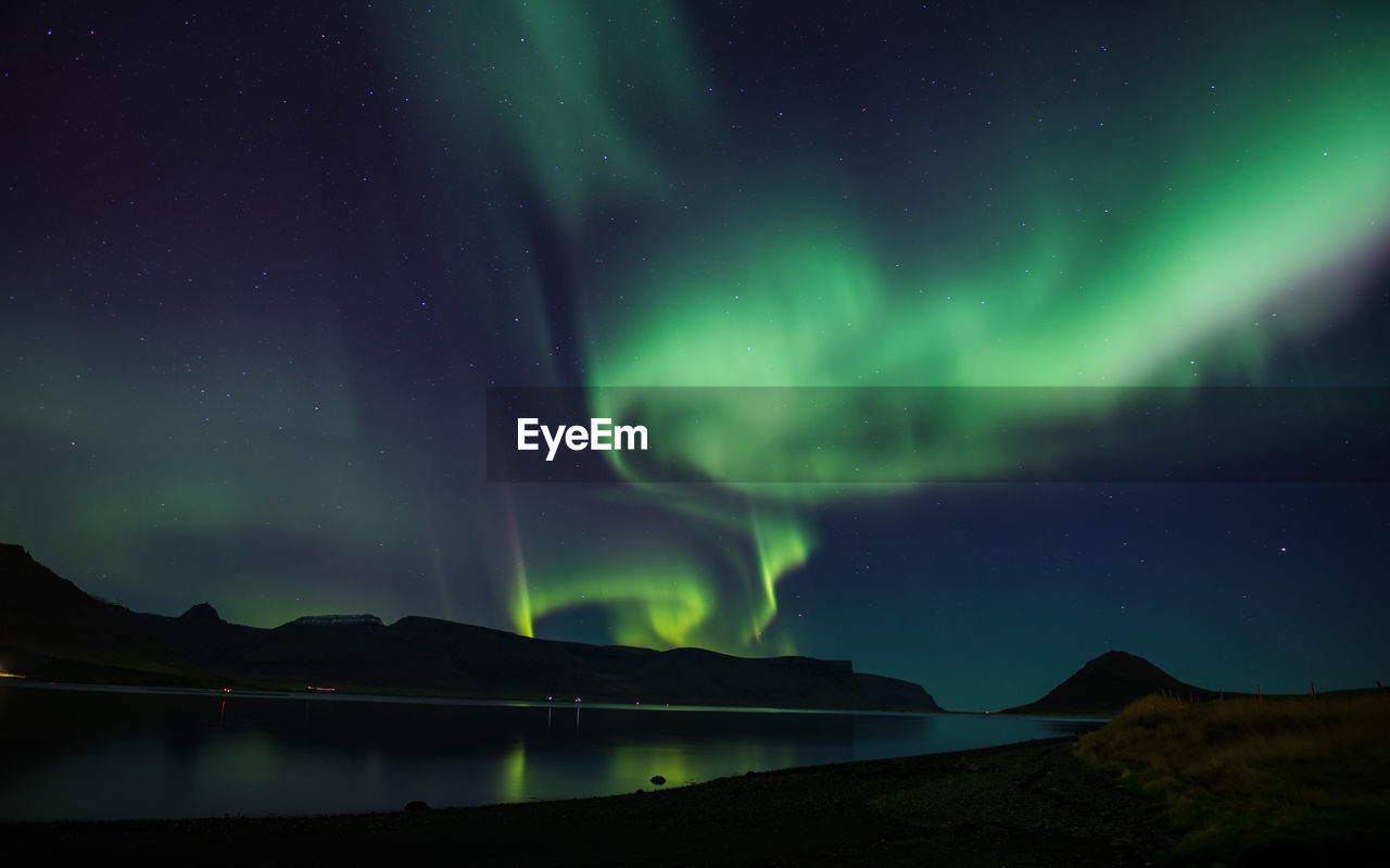 Scenic view of mountains against sky at night