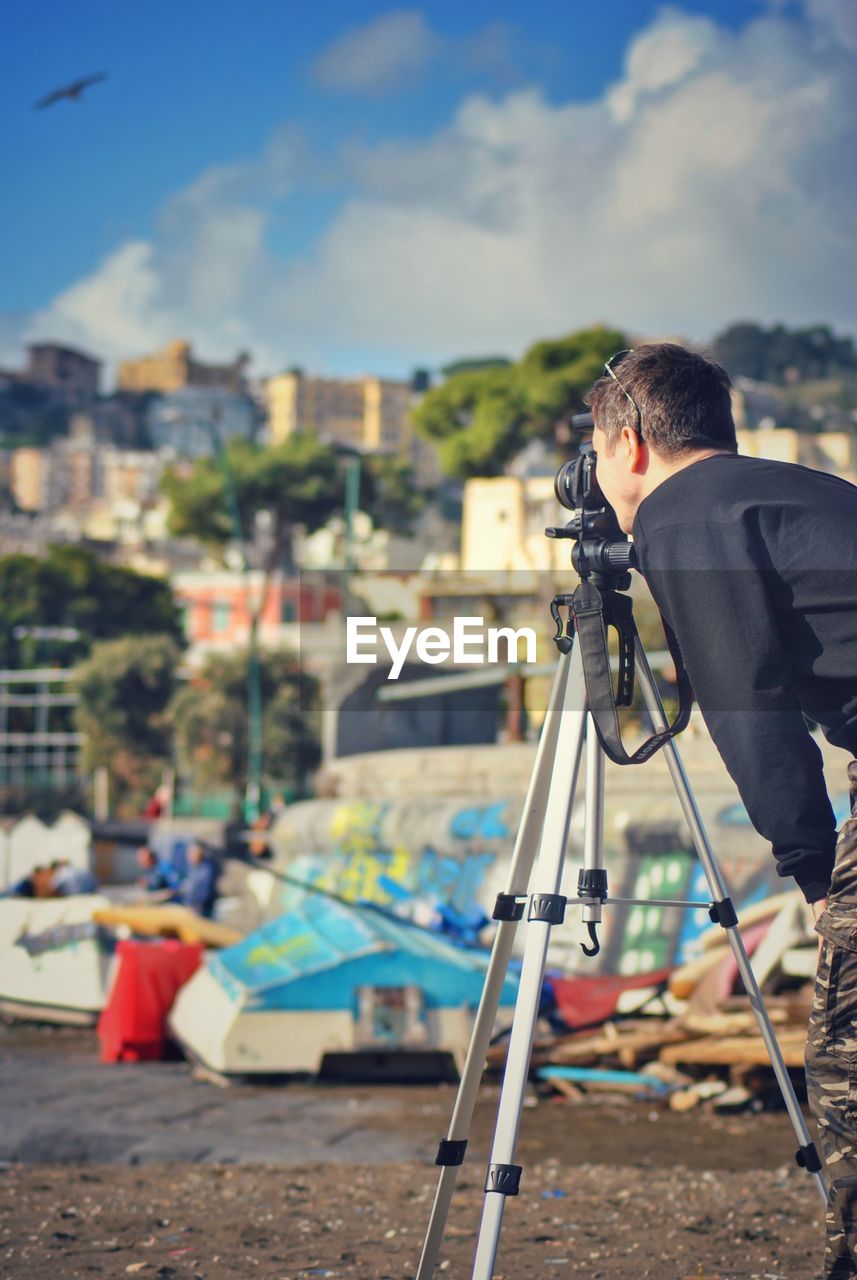 Man photographing  standing in city