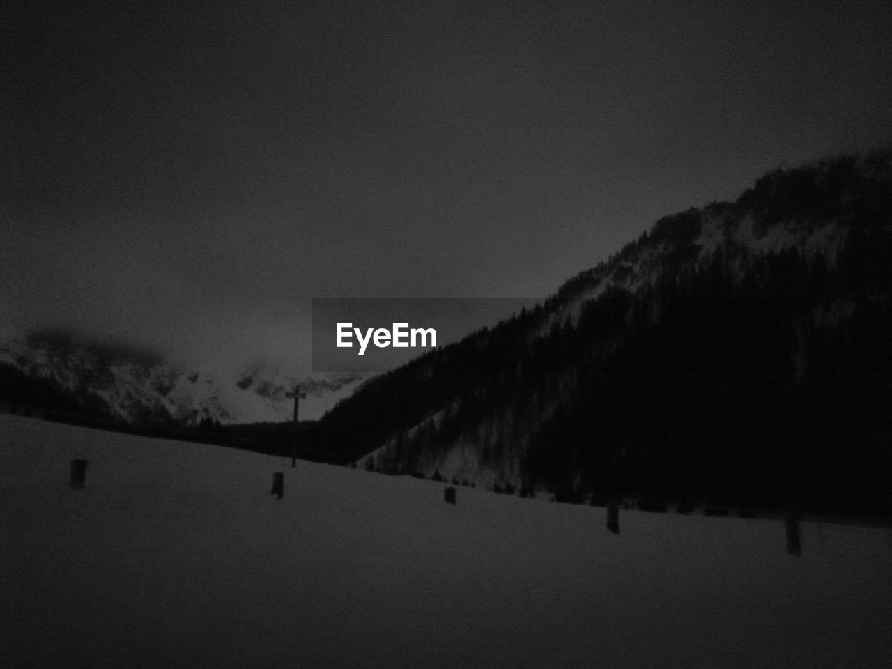 SCENIC VIEW OF SILHOUETTE MOUNTAINS AGAINST SKY DURING WINTER