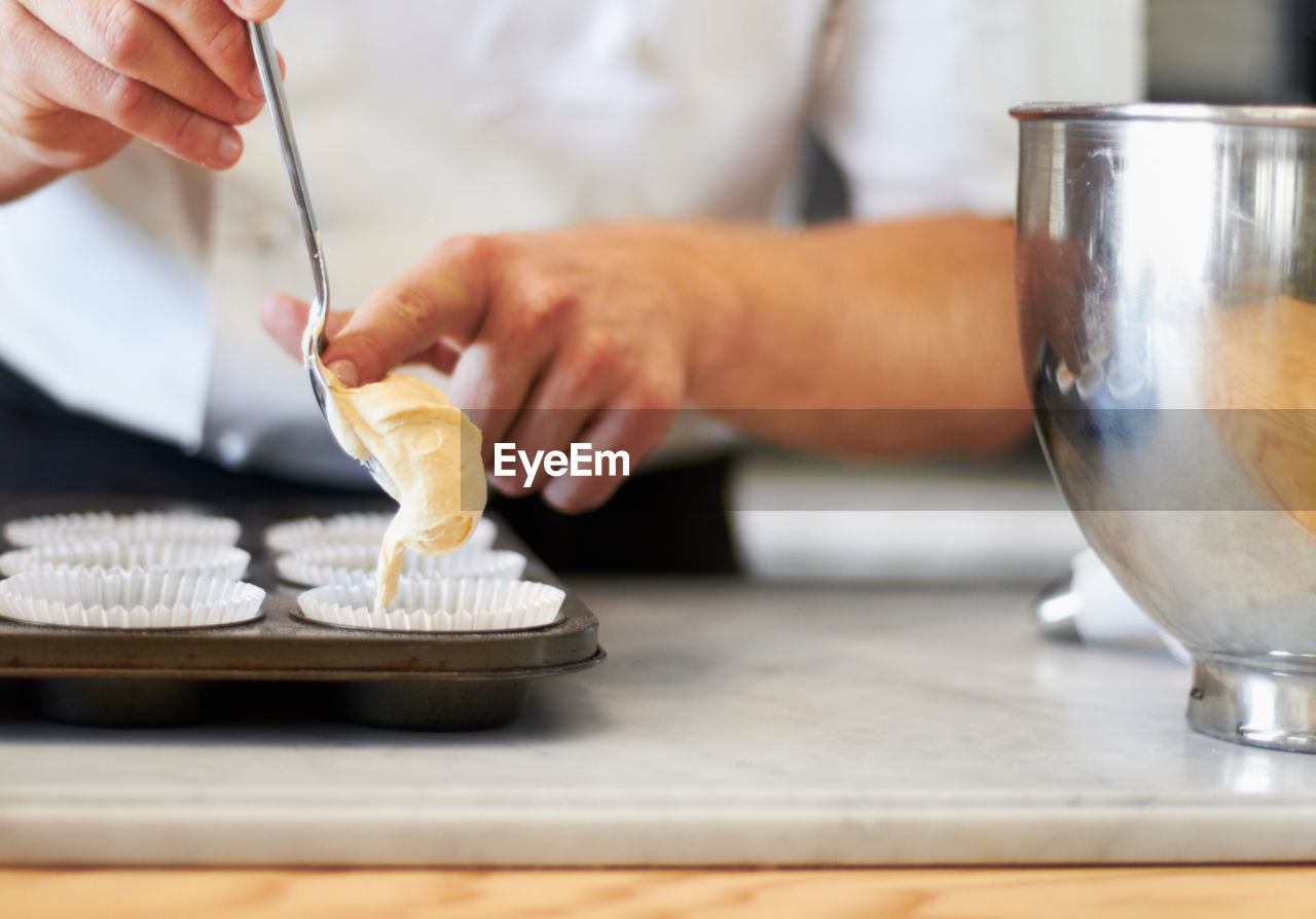 midsection of man preparing food on table