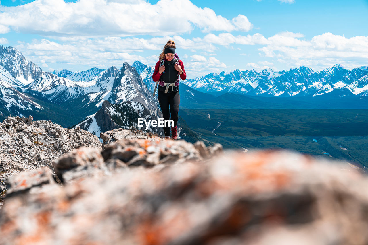 Hiker walking along mountain summit in kananaskis country