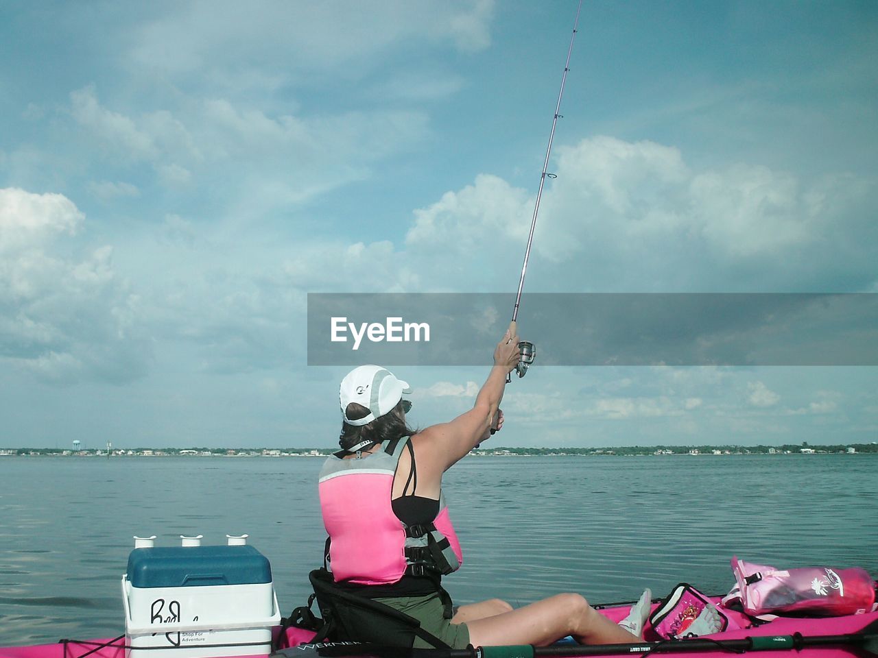 WOMAN FISHING IN WATER