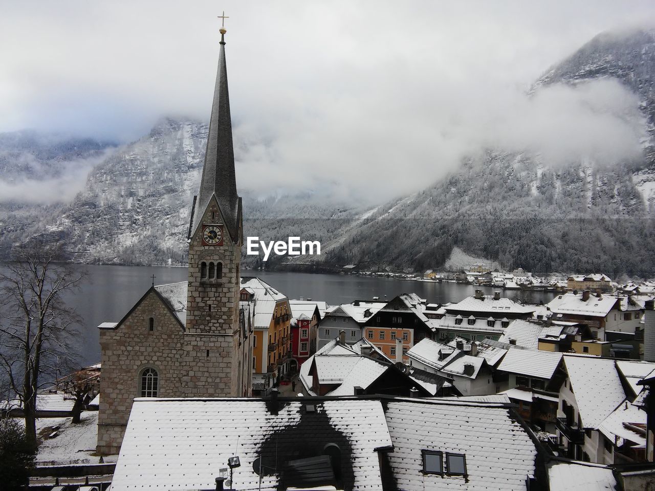 Buildings in city against sky during winter