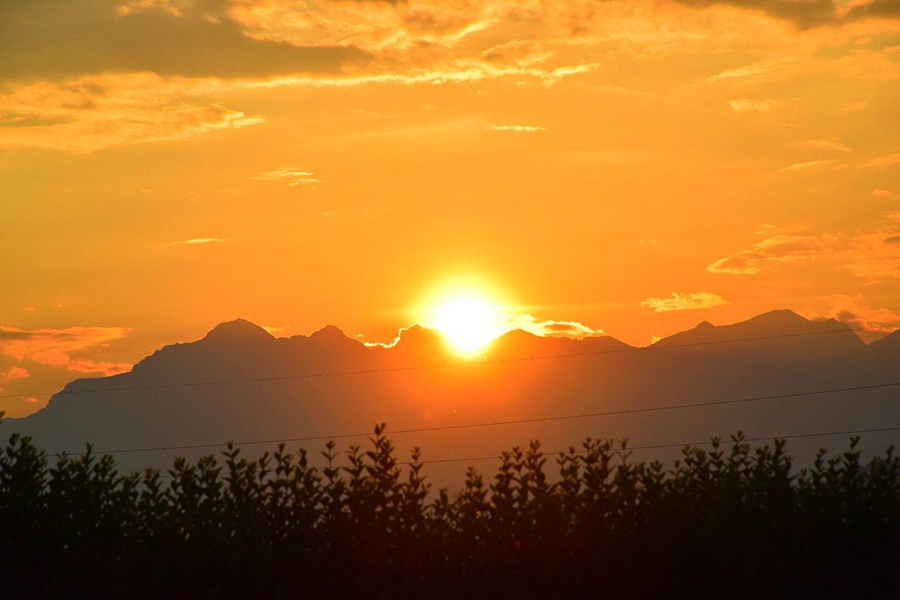 SCENIC VIEW OF MOUNTAINS AT SUNSET