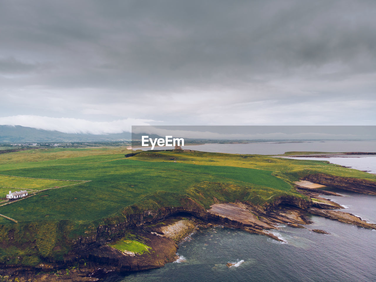 Scenic view of land and sea against sky