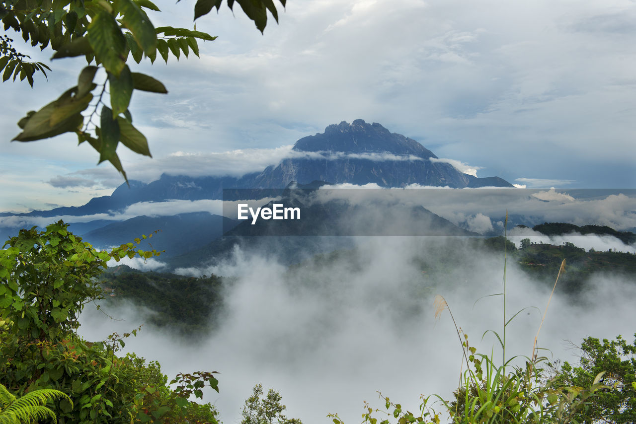 SCENIC VIEW OF CLOUDS AND MOUNTAINS AGAINST SKY