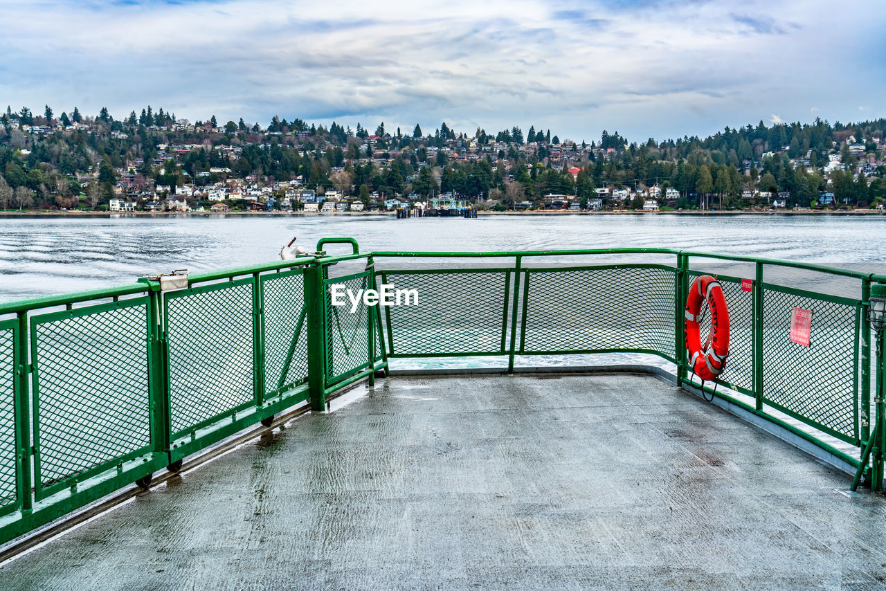 water, sky, architecture, cloud, walkway, nature, railing, built structure, city, no people, day, travel destinations, outdoors, building exterior, transportation, travel, sea, cityscape, boardwalk, tree, tourism, environment