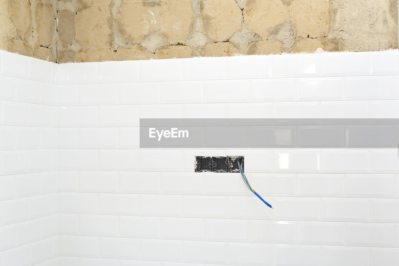 CLOSE-UP OF MAILBOX ON WALL IN BATHROOM