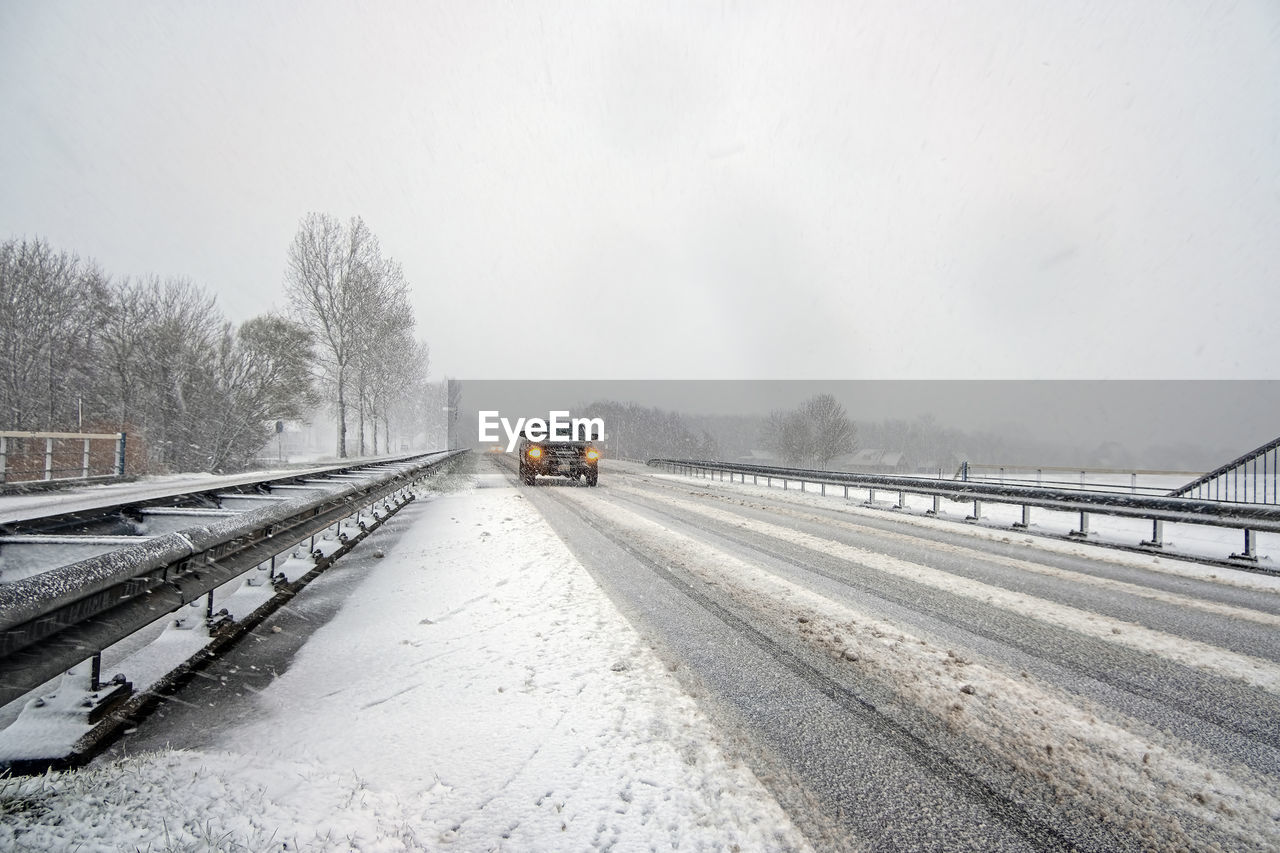 railroad track against clear sky during winter