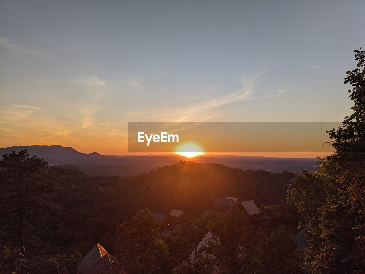 SCENIC VIEW OF MOUNTAINS AGAINST SKY AT SUNSET