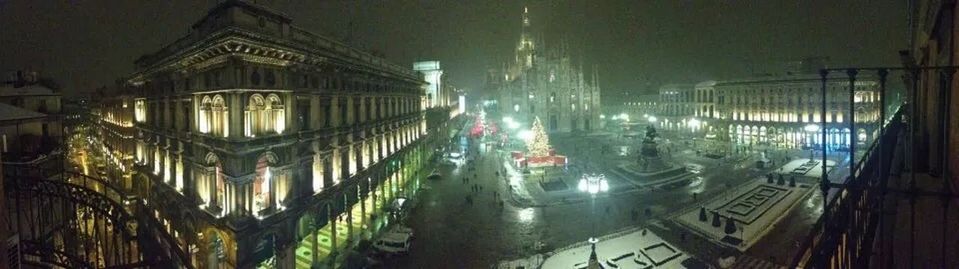 VIEW OF ILLUMINATED CITY AT NIGHT