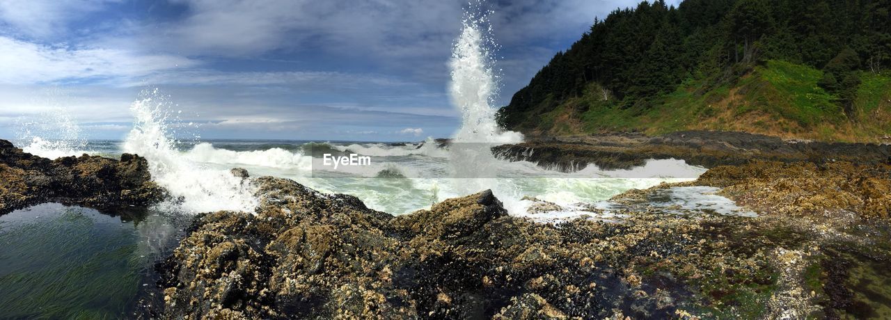 Waves splashing on rocky coastline at devils churn