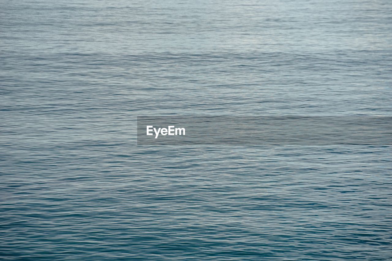 CLOSE-UP OF RIPPLED WATER IN BLUE SEA