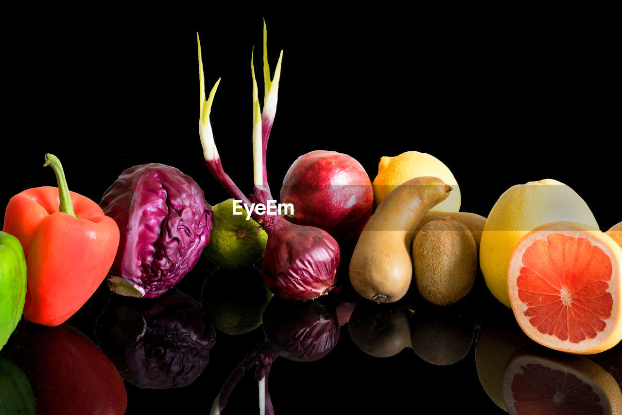 Close-up of fruits and vegetables against black background