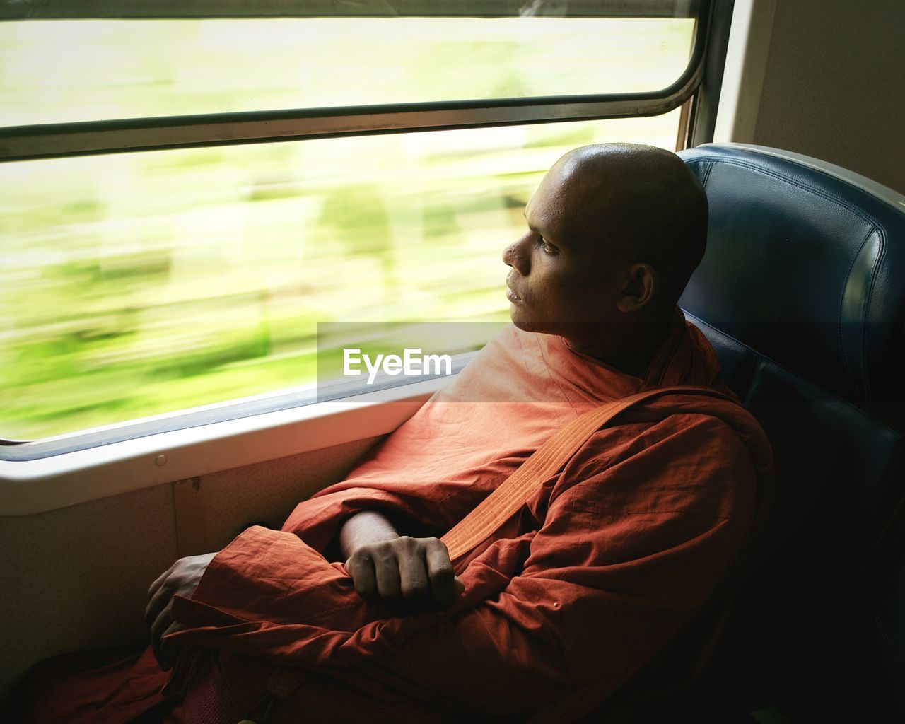 MAN LOOKING AT TRAIN WINDOW