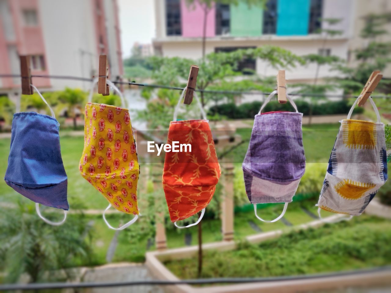 CLOSE-UP OF MULTI COLORED HANGING ON CLOTHESLINE