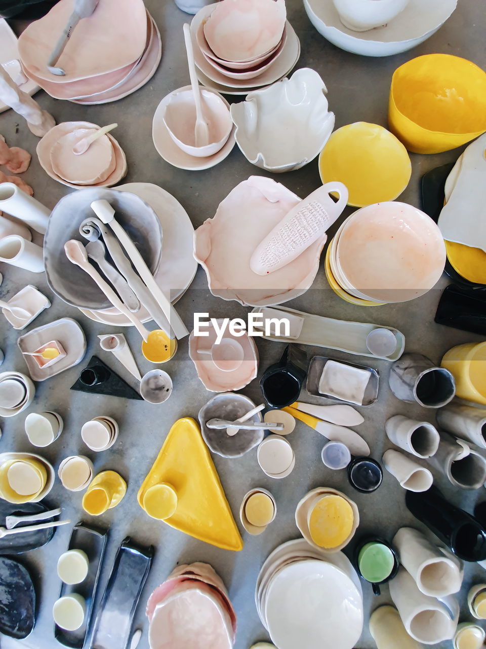 High angle view of multi colored clay pottery on table