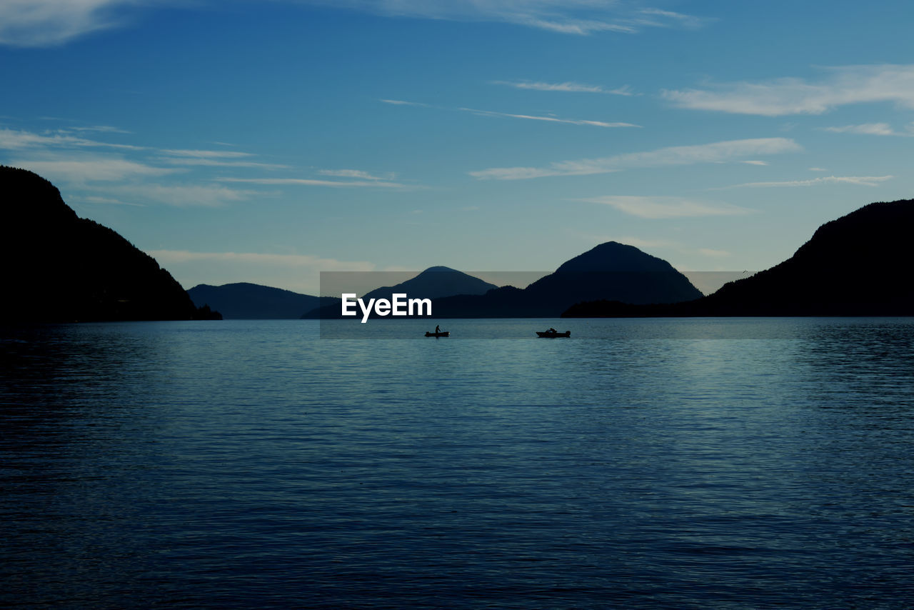 water, mountain, sky, horizon, scenics - nature, reflection, sea, beauty in nature, bay, tranquil scene, tranquility, ocean, nature, body of water, dusk, no people, blue, cloud, coast, mountain range, waterfront, idyllic, non-urban scene, outdoors, travel destinations, land, travel, day, shore, silhouette, transportation