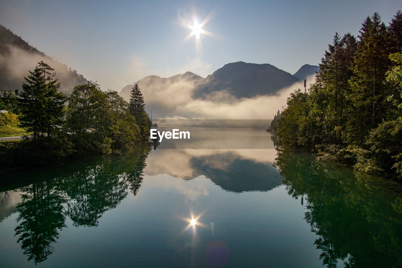 Scenic view of lake and mountains against sky