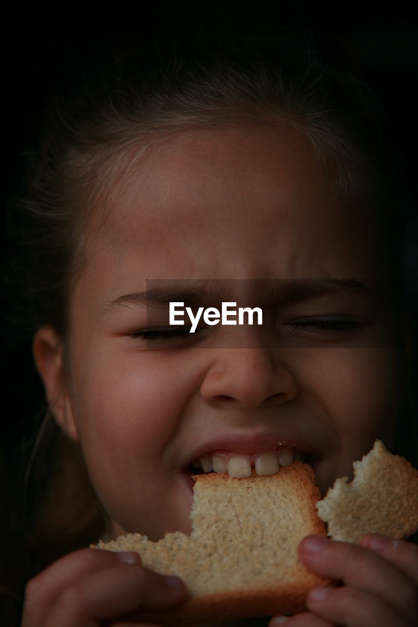 Close-up of girl eating food
