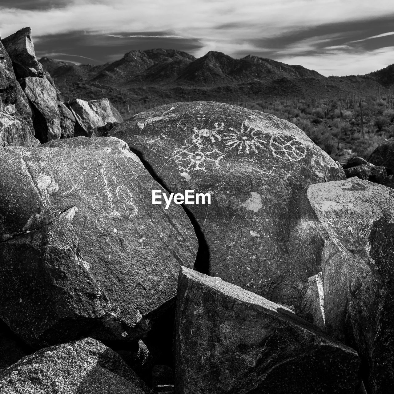 Close-up of boulder rocks with mountains in background