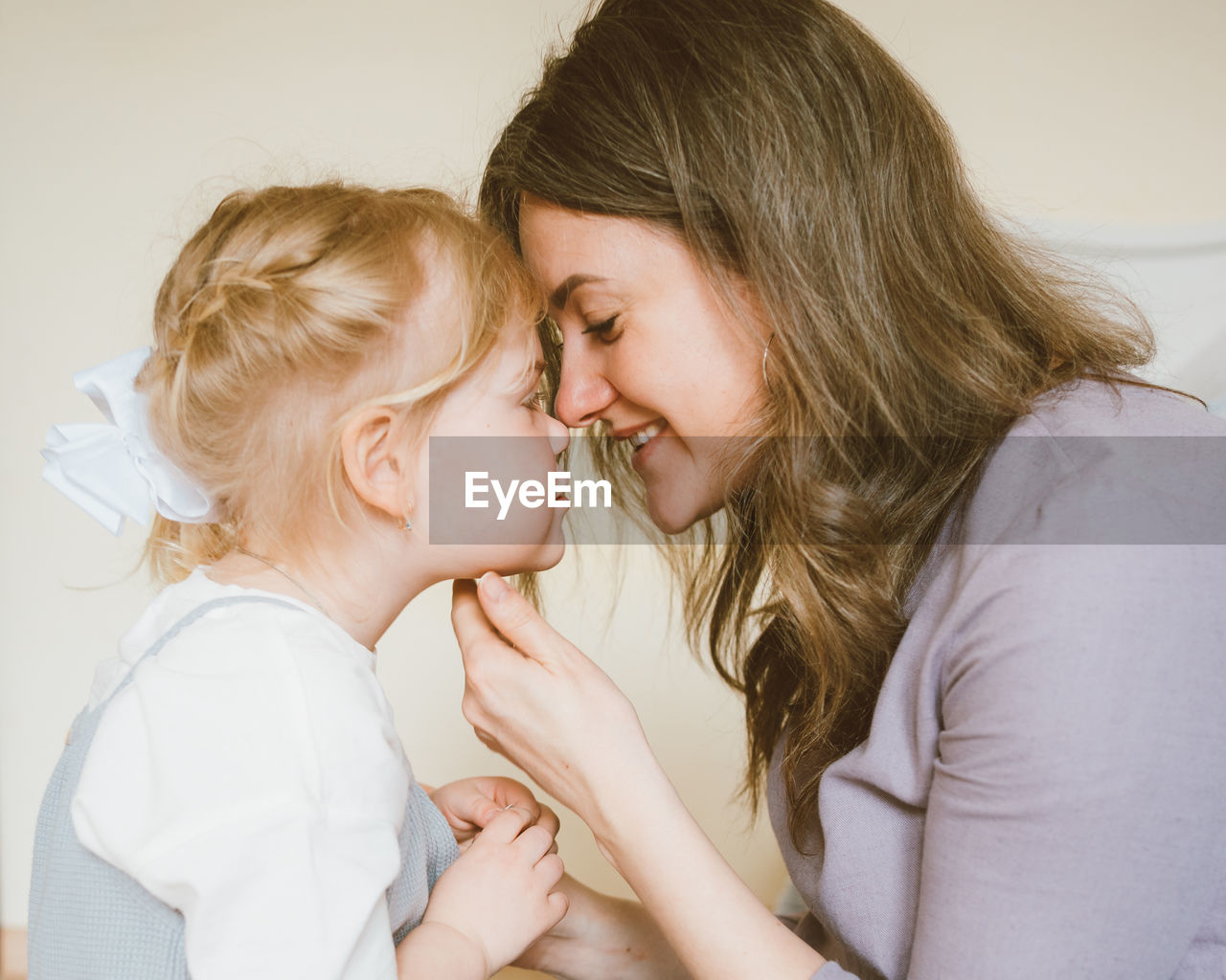 Mother and daughter sitting at home