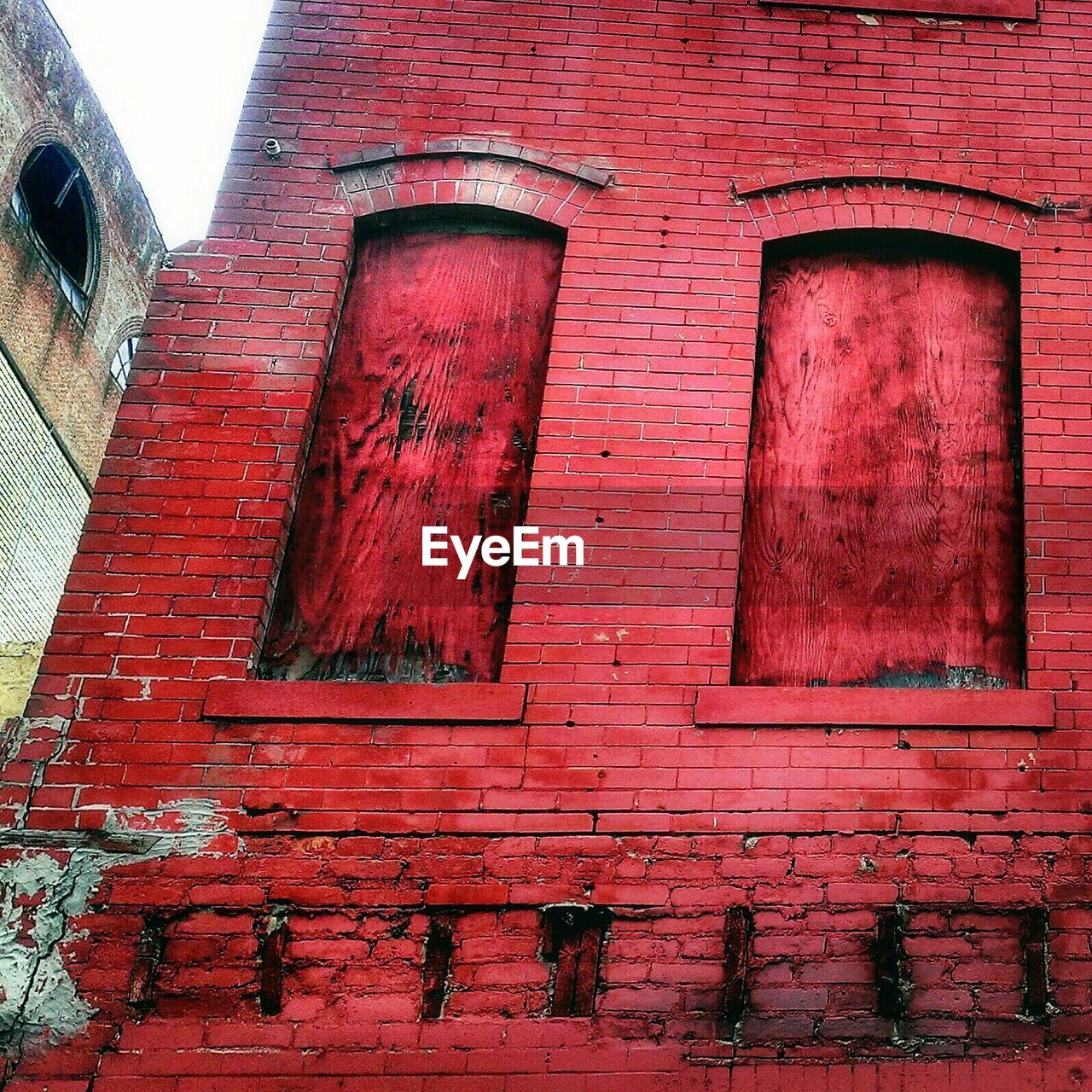 Low angle view of abandoned red building