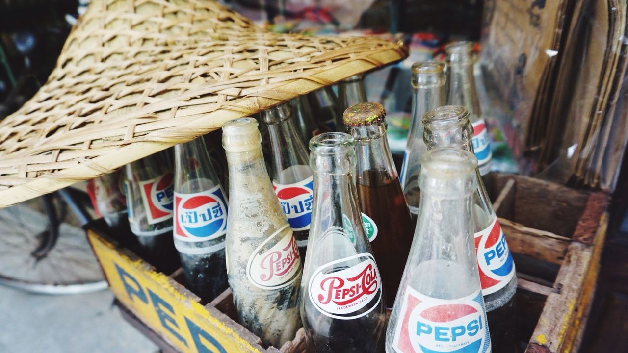 CLOSE-UP OF TEXT IN BASKET ON BOTTLE