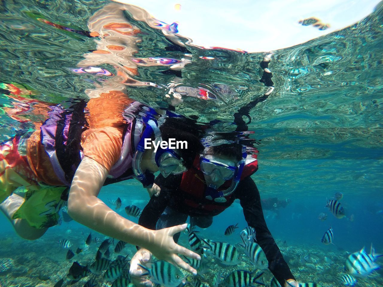 REFLECTION OF MAN IN SEA