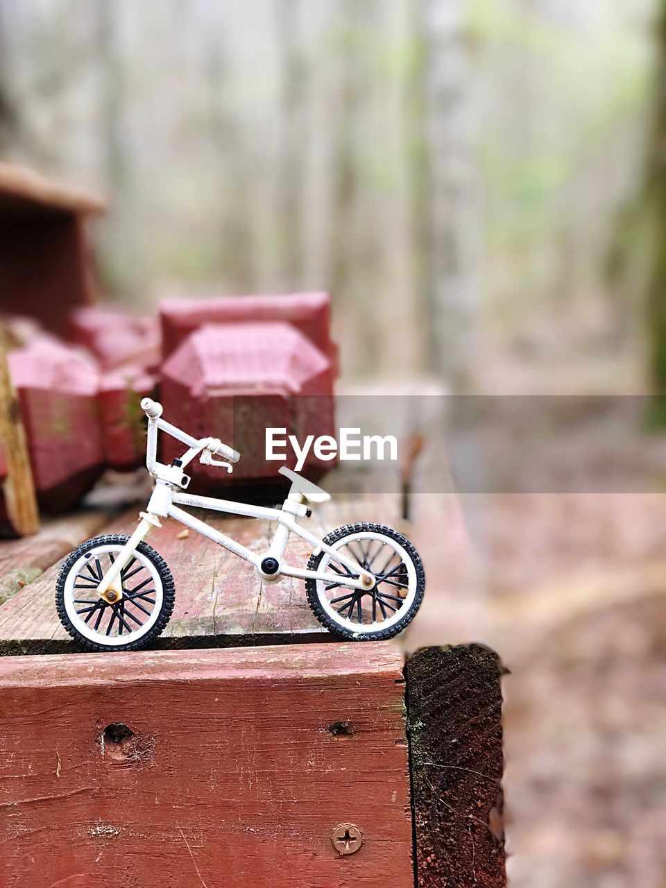 Close-up of bicycle toy on wooden table