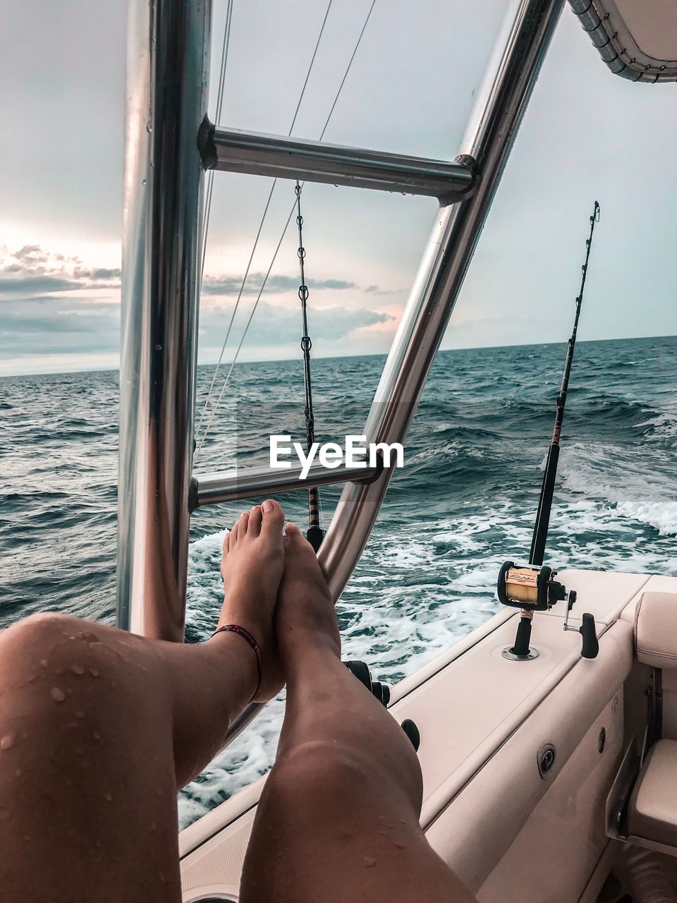 Low section of woman relaxing on yacht