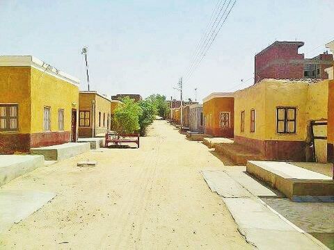 EMPTY ROAD WITH BUILDINGS IN BACKGROUND