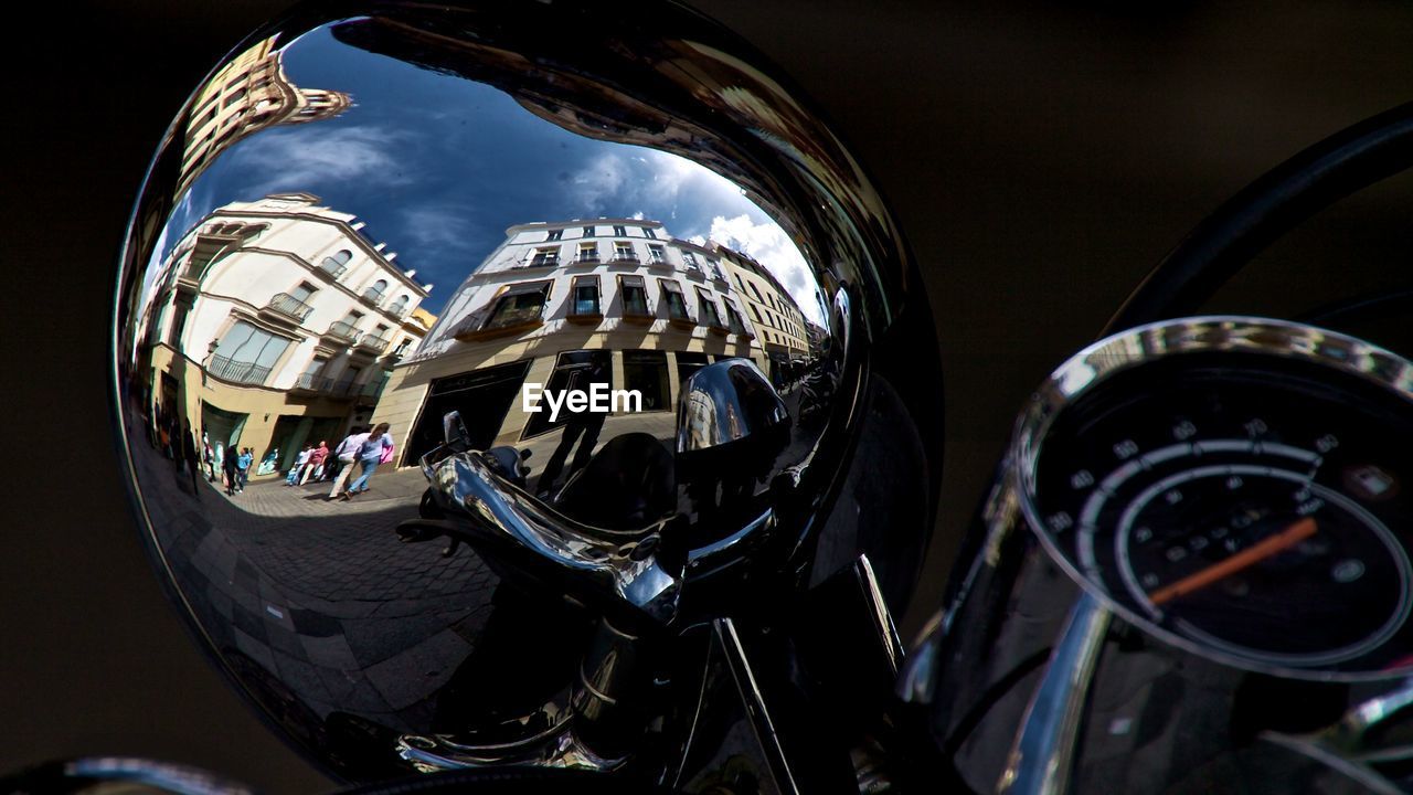 CLOSE-UP REFLECTION OF BUILDING IN MIRROR