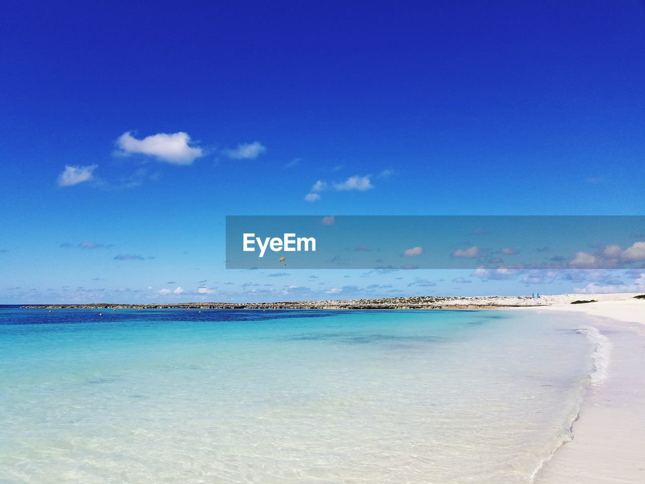 Scenic view of beach against blue sky