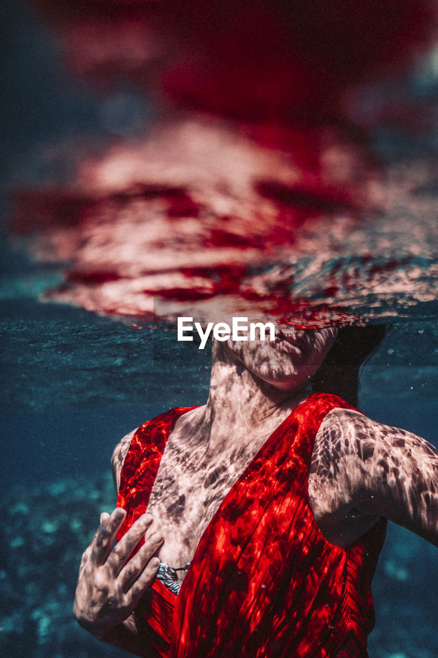 Young beautiful woman under water surface