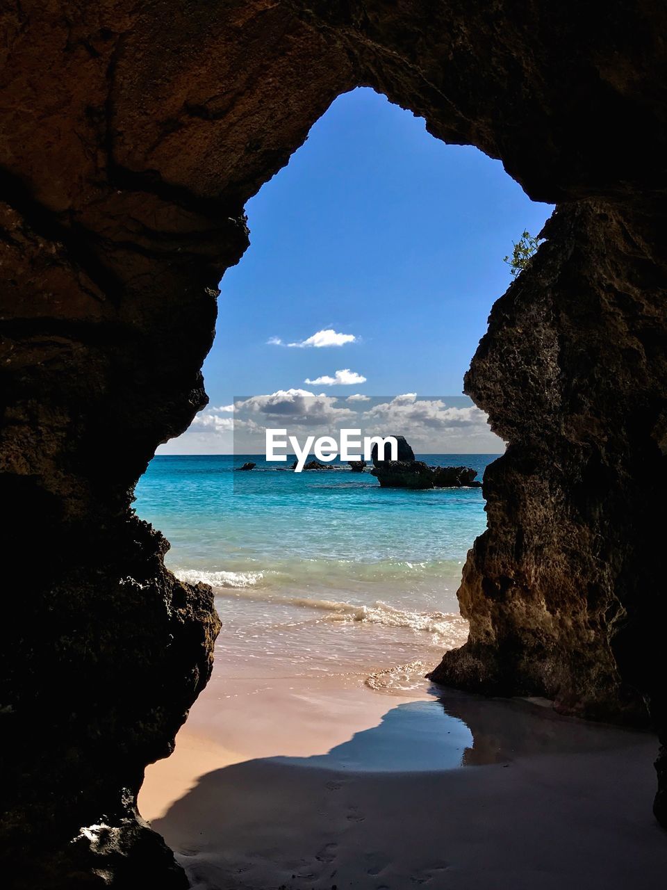 Scenic view of sea seen through cave