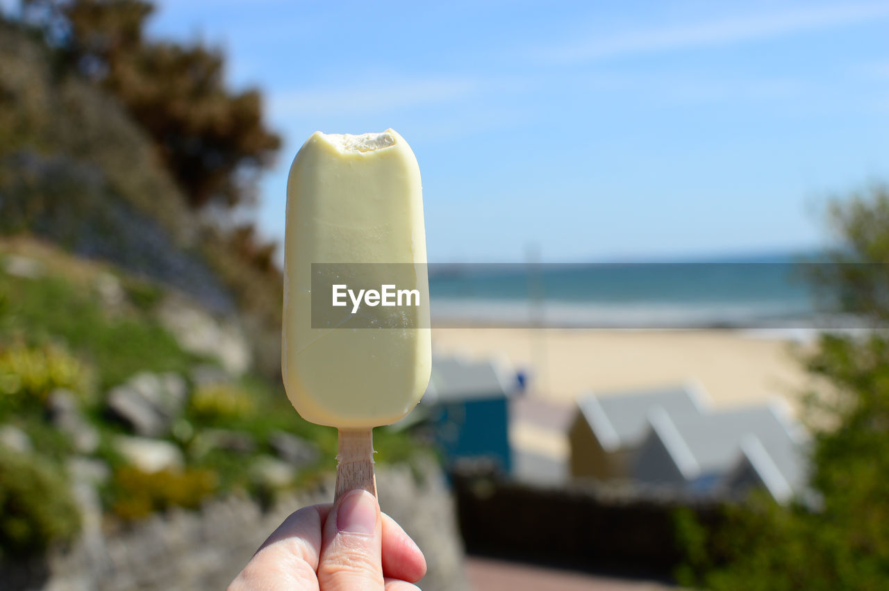 Close-up of hand holding ice cream