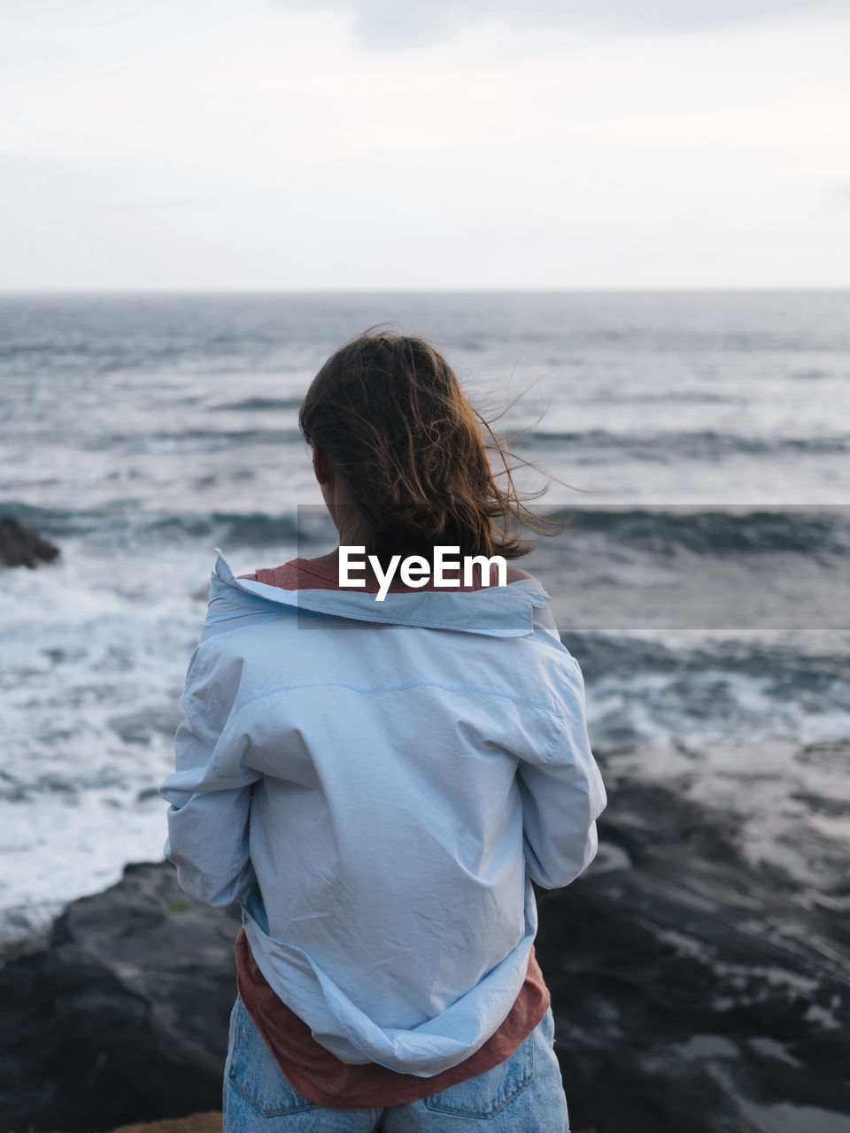 Young woman looking at ocean