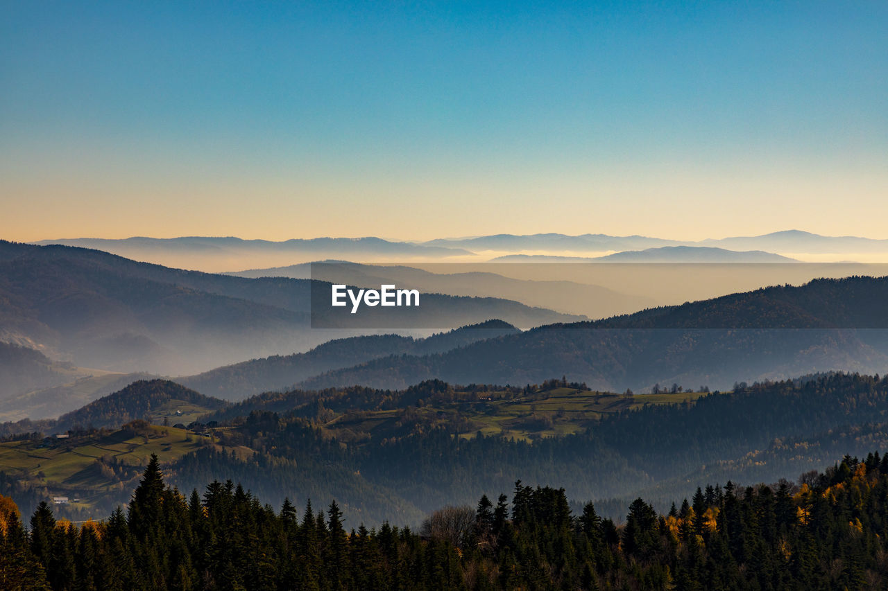 Scenic view of mountains against sky during sunset