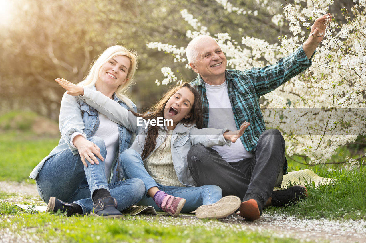 Portrait of happy family sitting in park